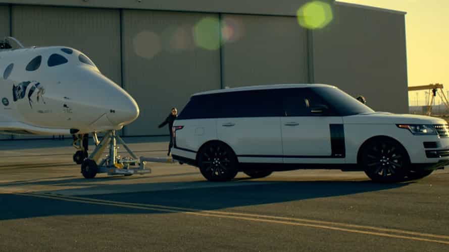 White Range Rover with private jet behind